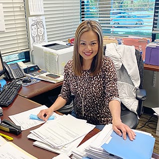 Demi_WIC2 Demi Nguyen at desk in accounting