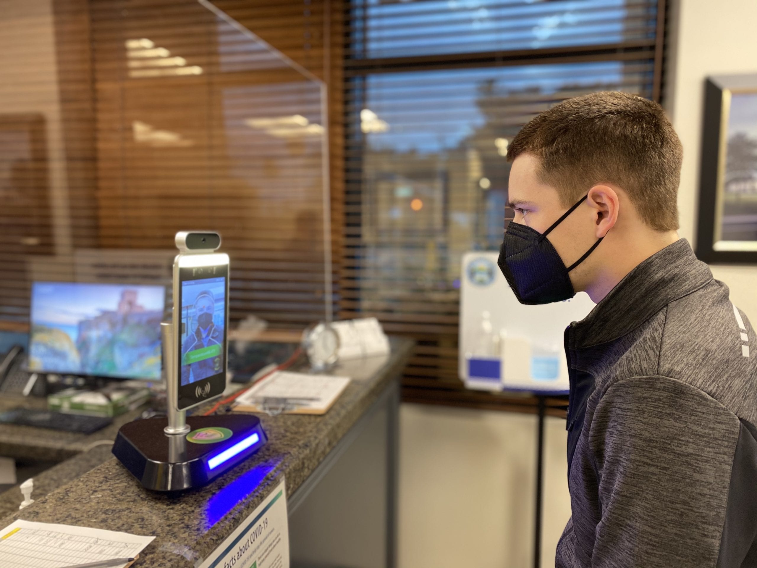 Employee gets thermal scan at kiosk